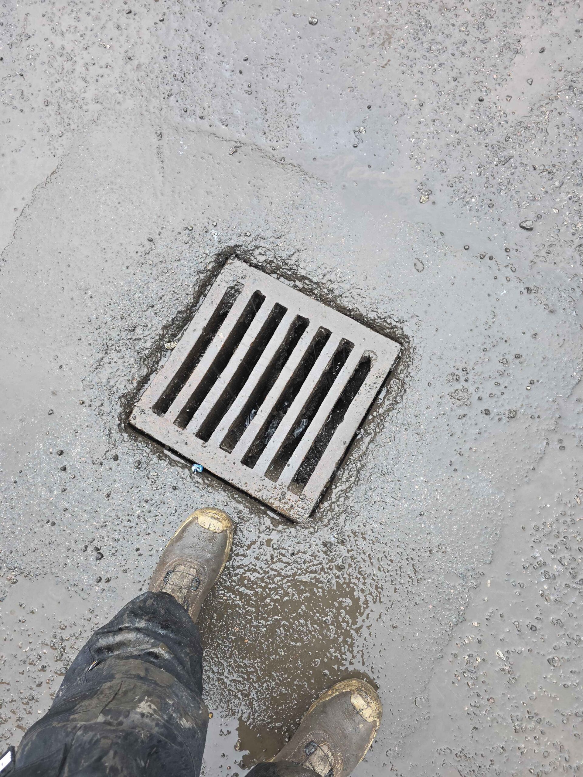 HydraFlow drainage engineer on site with work boots at drain