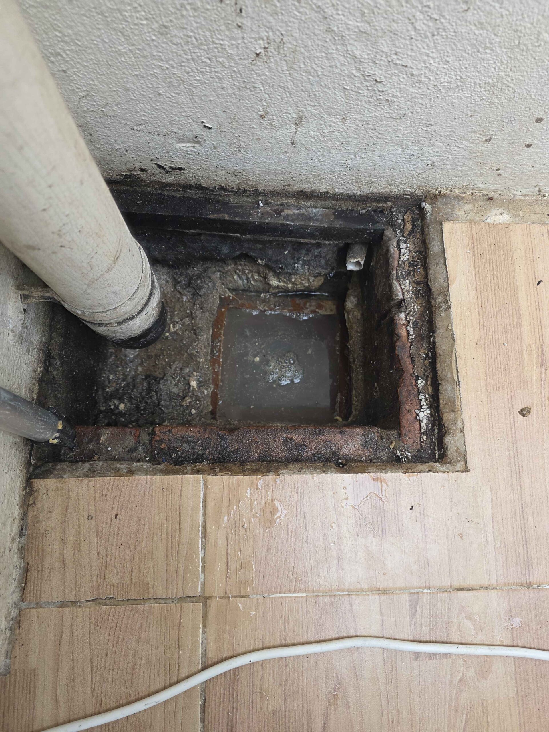 Indoor drainage chamber with pipes being inspected